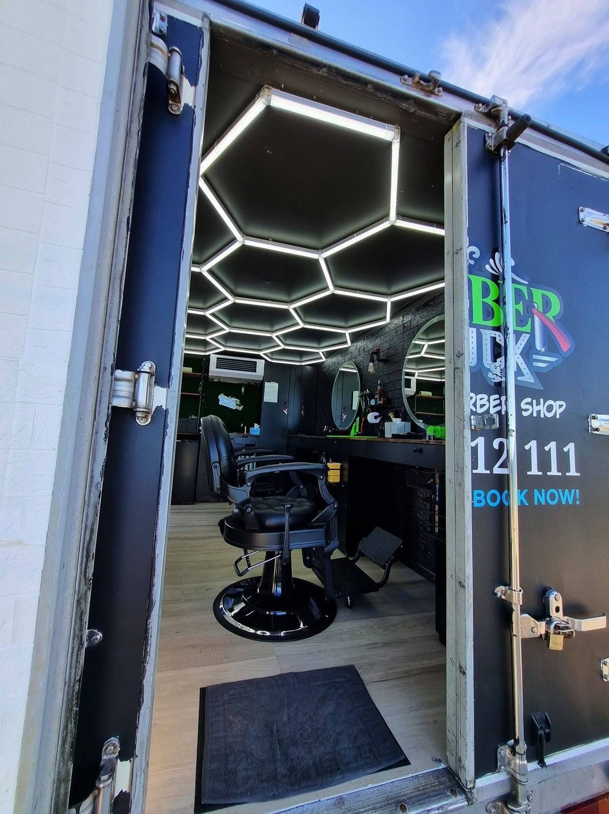 Looking into the barber truck through its open rear doors